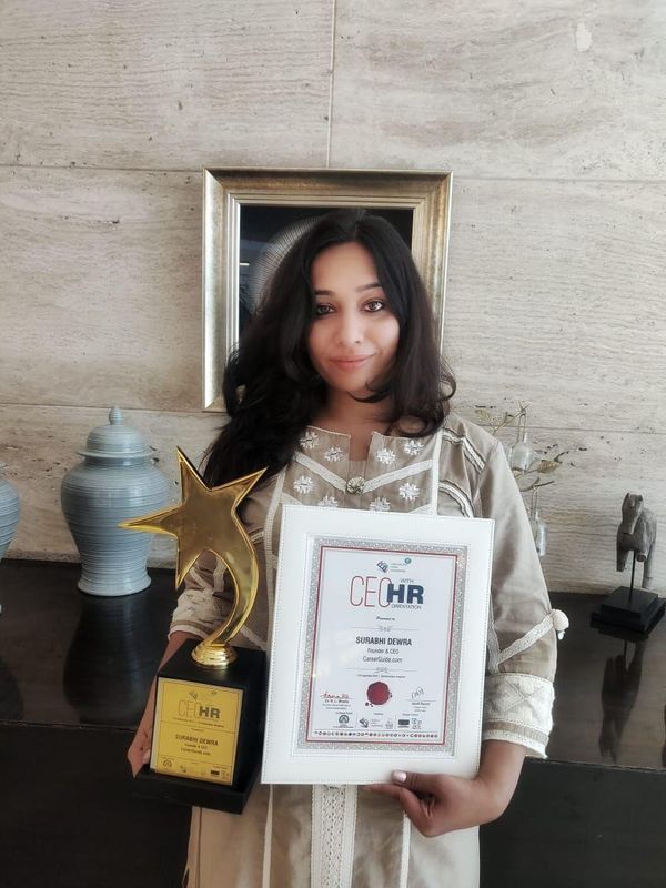 Surabhi Dewra holding the CEO with HR Orientation trophy and certificate